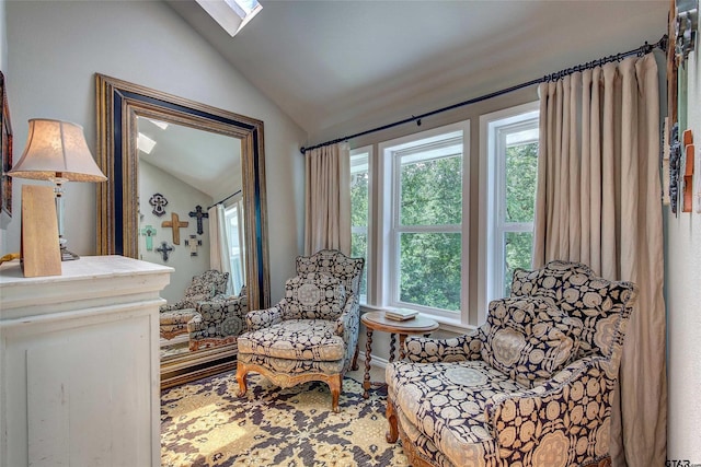 living area featuring vaulted ceiling with skylight