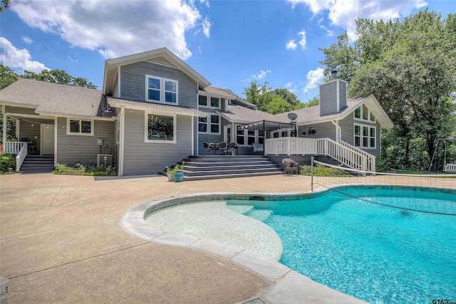 view of swimming pool with a patio area and a deck