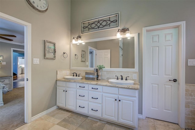 bathroom with tasteful backsplash, vanity, ceiling fan, tile patterned floors, and ornamental molding