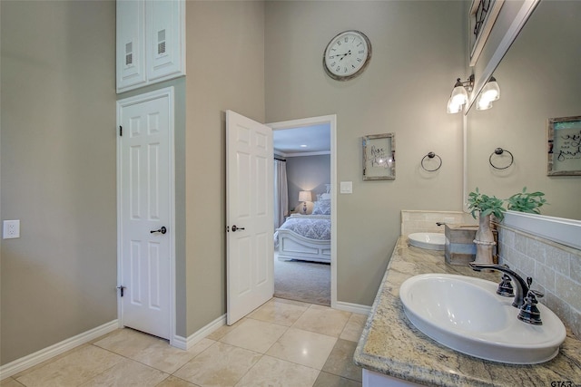 bathroom with tile patterned flooring, ornamental molding, and vanity