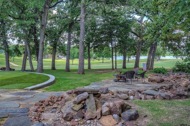 view of community with a patio area and a lawn