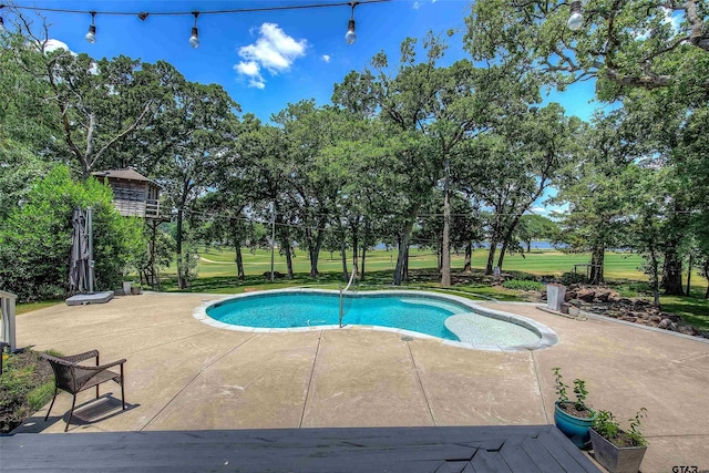 view of pool featuring a yard and a patio