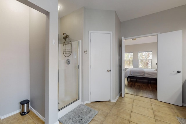 bathroom featuring tile patterned floors and a shower with door