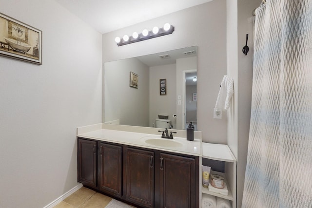 bathroom featuring tile patterned flooring, vanity, and toilet