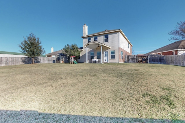 back of house featuring a yard