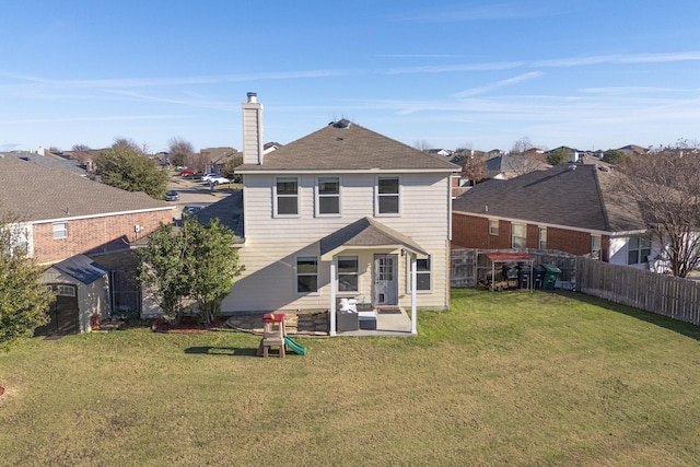 back of property featuring a patio, a yard, and a storage unit