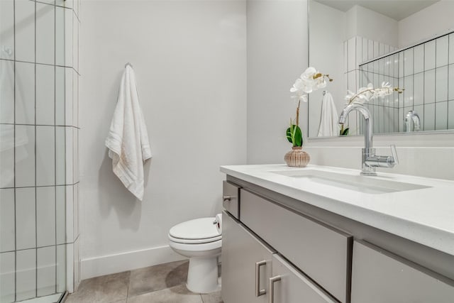 bathroom featuring toilet, tile patterned flooring, and vanity