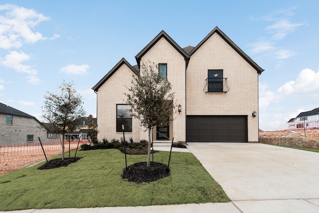 view of front of home with a garage and a front yard