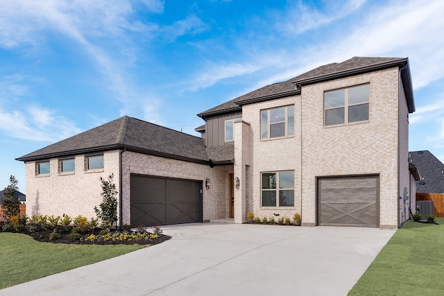 view of front of property with a front lawn and central AC