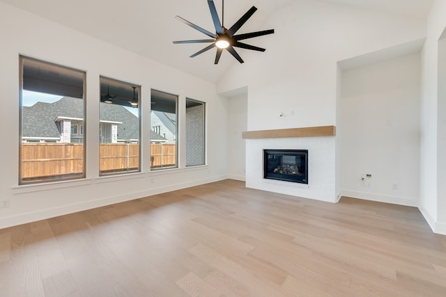 unfurnished living room featuring light wood-type flooring and vaulted ceiling