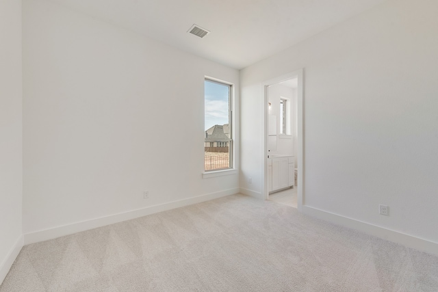 spare room with light colored carpet