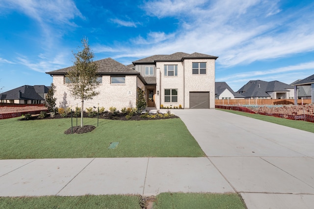 view of front facade featuring a garage and a front lawn