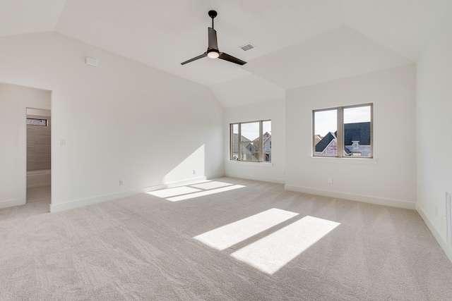 spare room featuring ceiling fan, light colored carpet, and lofted ceiling