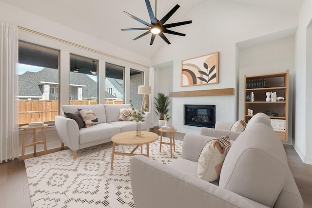 living room featuring ceiling fan, lofted ceiling, and hardwood / wood-style flooring