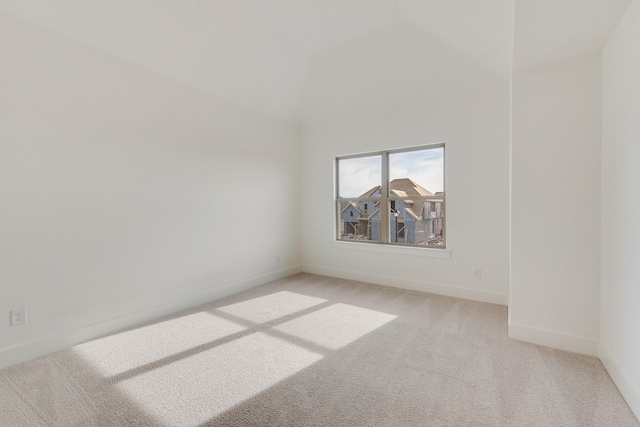 carpeted empty room featuring a high ceiling