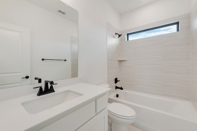 full bathroom featuring toilet, tiled shower / bath combo, and vanity