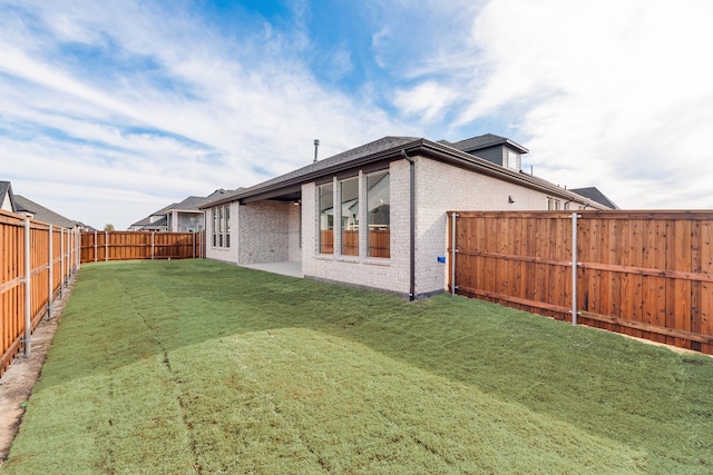 back of house featuring a yard