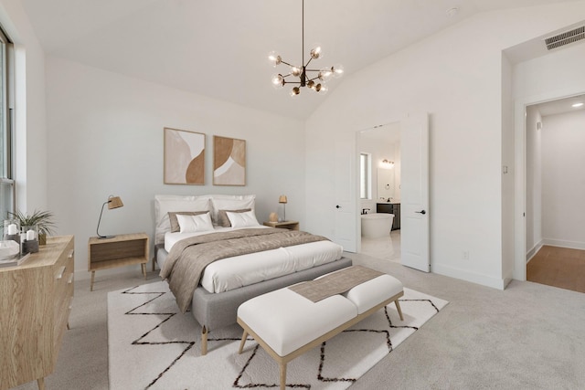 bedroom featuring light colored carpet, connected bathroom, a chandelier, and vaulted ceiling