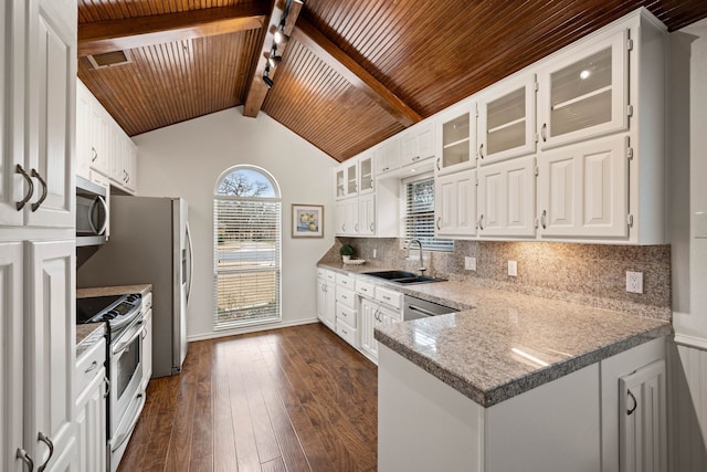 kitchen with backsplash, vaulted ceiling with beams, sink, stainless steel appliances, and white cabinets