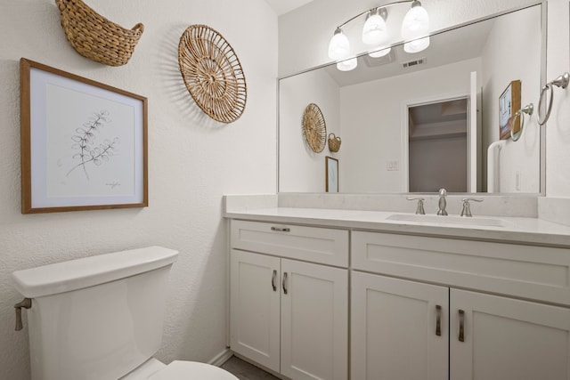 bathroom with toilet and vanity