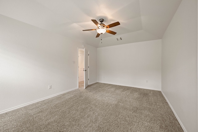 carpeted empty room with ceiling fan and lofted ceiling