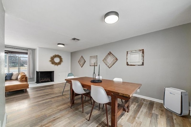 dining area with hardwood / wood-style floors