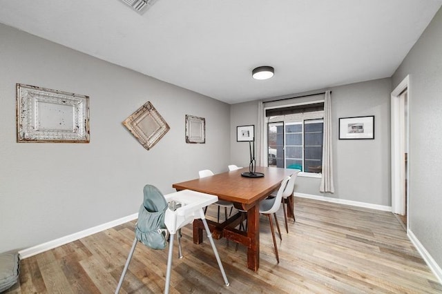 dining area with light hardwood / wood-style floors