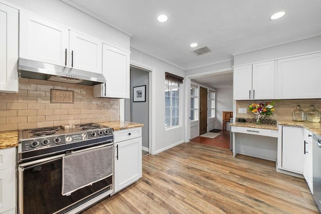 kitchen with light hardwood / wood-style flooring, white cabinets, light stone counters, and electric range oven