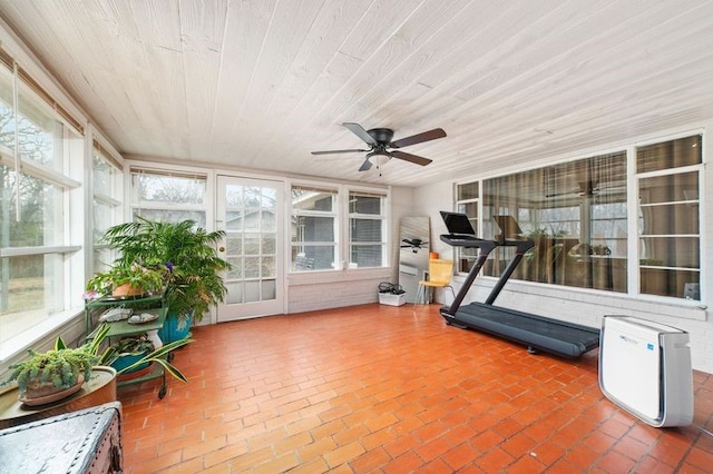 unfurnished sunroom with ceiling fan and wooden ceiling