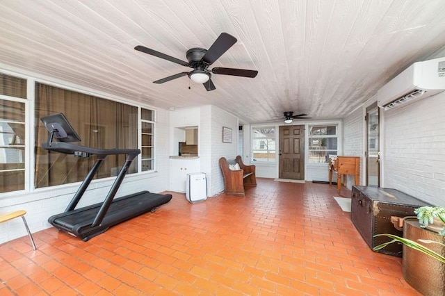 workout area featuring a wall unit AC, ceiling fan, brick wall, and wood ceiling