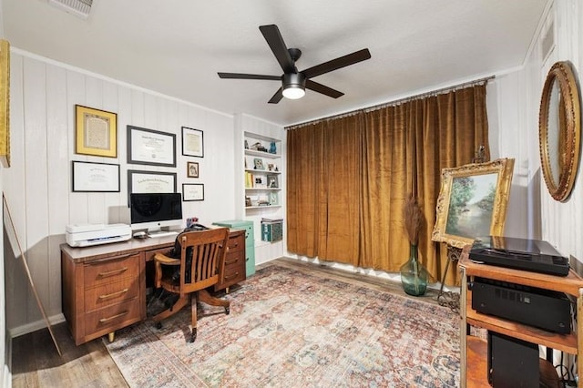 office space with ceiling fan, built in features, and hardwood / wood-style floors