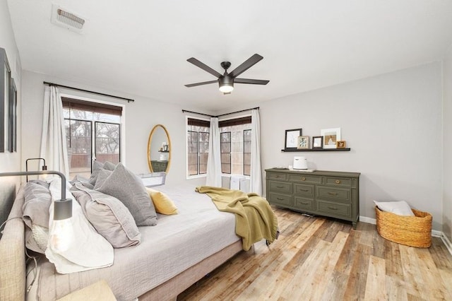 bedroom with ceiling fan and light hardwood / wood-style flooring