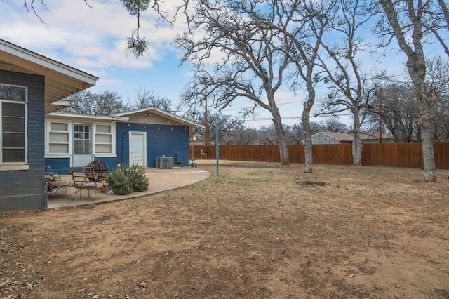 view of yard featuring a patio area and central AC