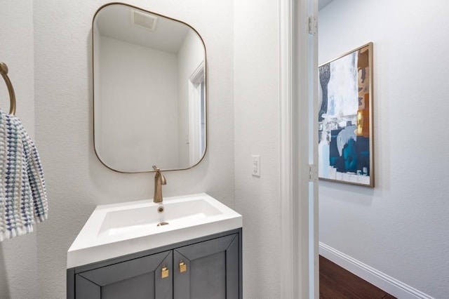 bathroom with hardwood / wood-style flooring and vanity