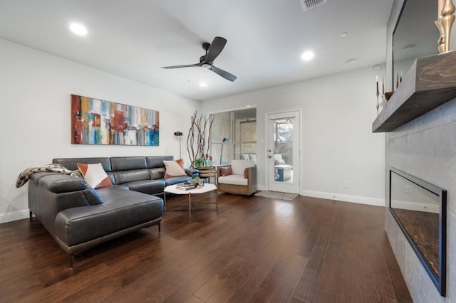 living room with ceiling fan and dark wood-type flooring