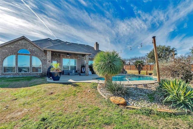 back of house with a yard, ceiling fan, and a patio area