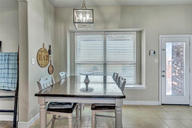 dining room featuring light tile patterned floors and a notable chandelier