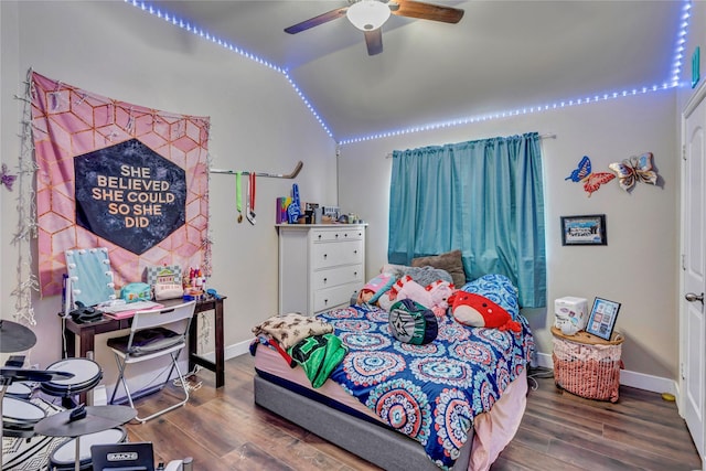 bedroom with ceiling fan, vaulted ceiling, and hardwood / wood-style flooring