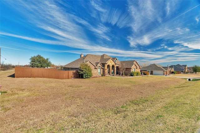 view of front of property with a garage and a front lawn