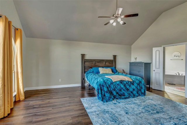 bedroom featuring ceiling fan, dark wood-type flooring, ensuite bathroom, and vaulted ceiling