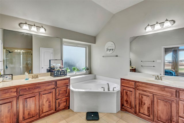 bathroom with vaulted ceiling, tile patterned flooring, shower with separate bathtub, and vanity