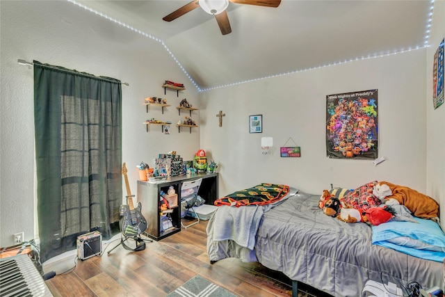 bedroom with ceiling fan, light hardwood / wood-style floors, and lofted ceiling