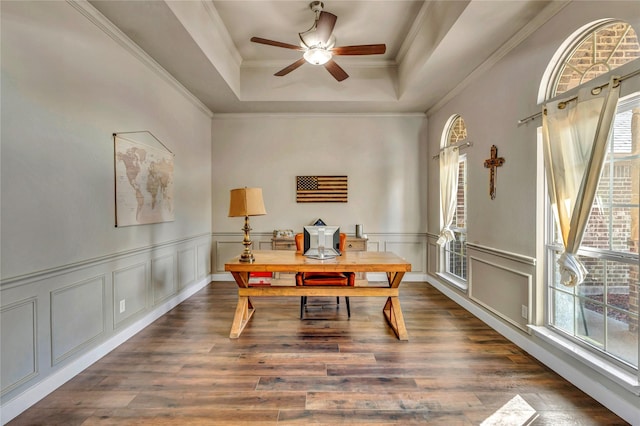 office with ceiling fan, dark hardwood / wood-style flooring, crown molding, and a tray ceiling