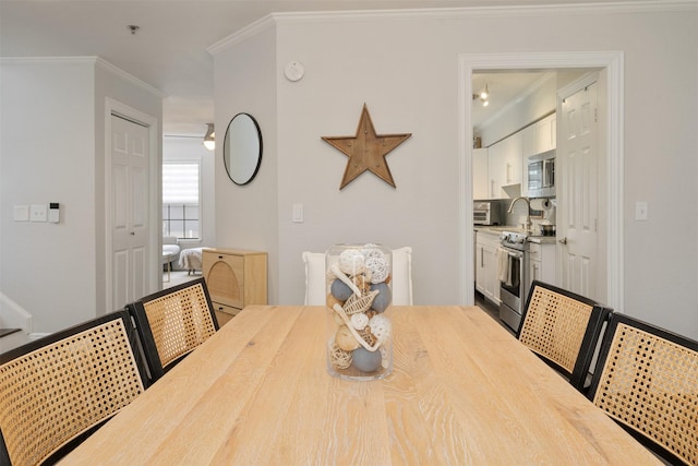 dining room featuring crown molding