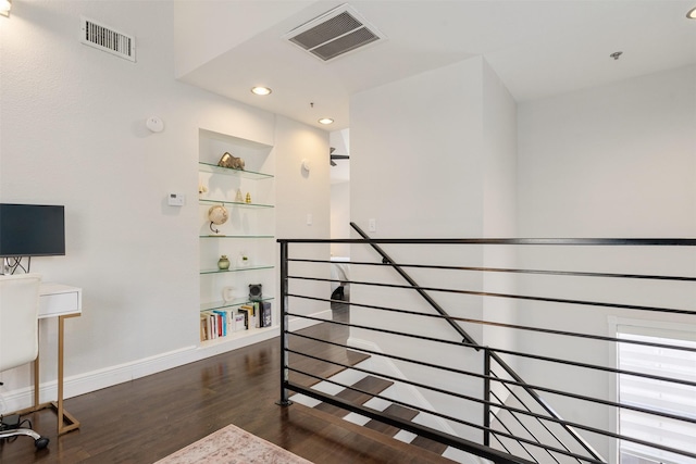 interior space featuring wood-type flooring and built in shelves