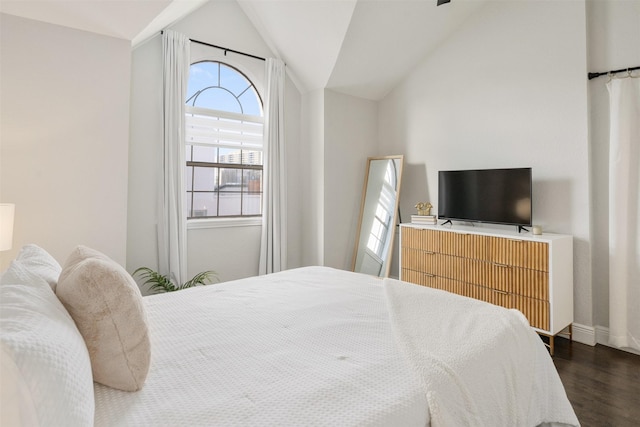 bedroom with dark wood-type flooring and lofted ceiling