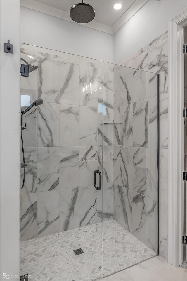 full bath featuring crown molding and a marble finish shower