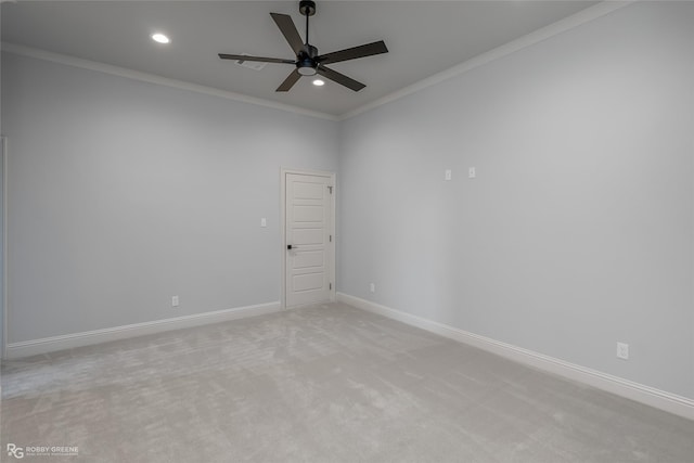 spare room with light carpet, ornamental molding, recessed lighting, and baseboards