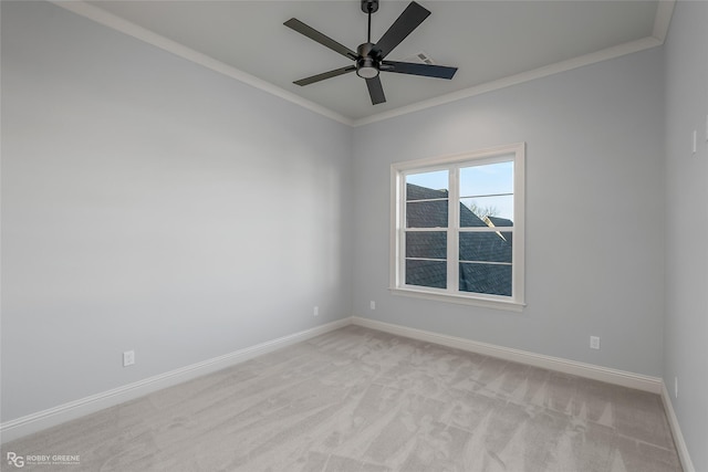 spare room featuring ornamental molding, light colored carpet, ceiling fan, and baseboards