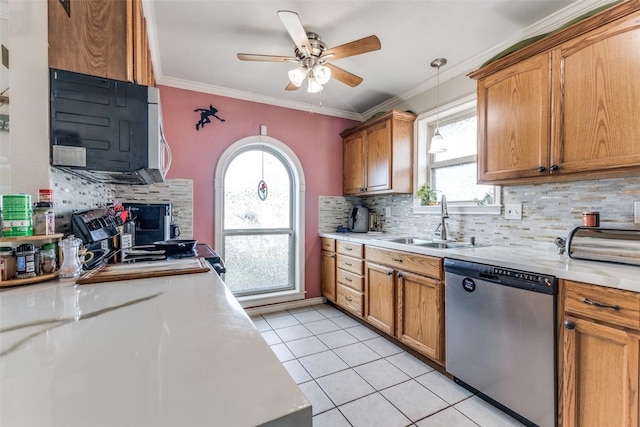 kitchen with light tile patterned flooring, dishwasher, hanging light fixtures, a wealth of natural light, and sink